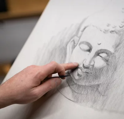 Students draws a Buddha head