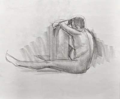 Sitting man drawn with charcoal pencils