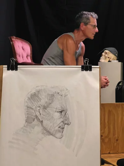 Man posing in art school for a portrait drawing